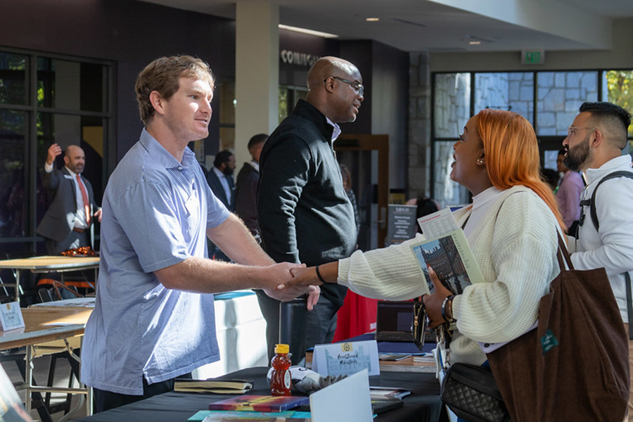 Employer and student shaking hands at career fair