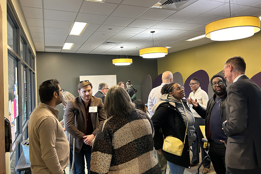 Alumni talk to one another in a reception