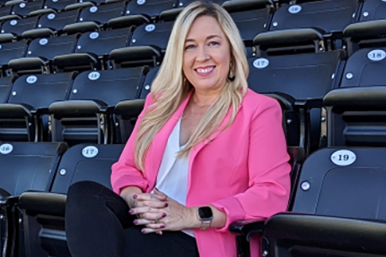 Kristi Dosh '03 seated in a stadium