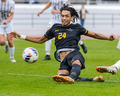 Stormy Petrel soccer player makes an epic slide for the ball.